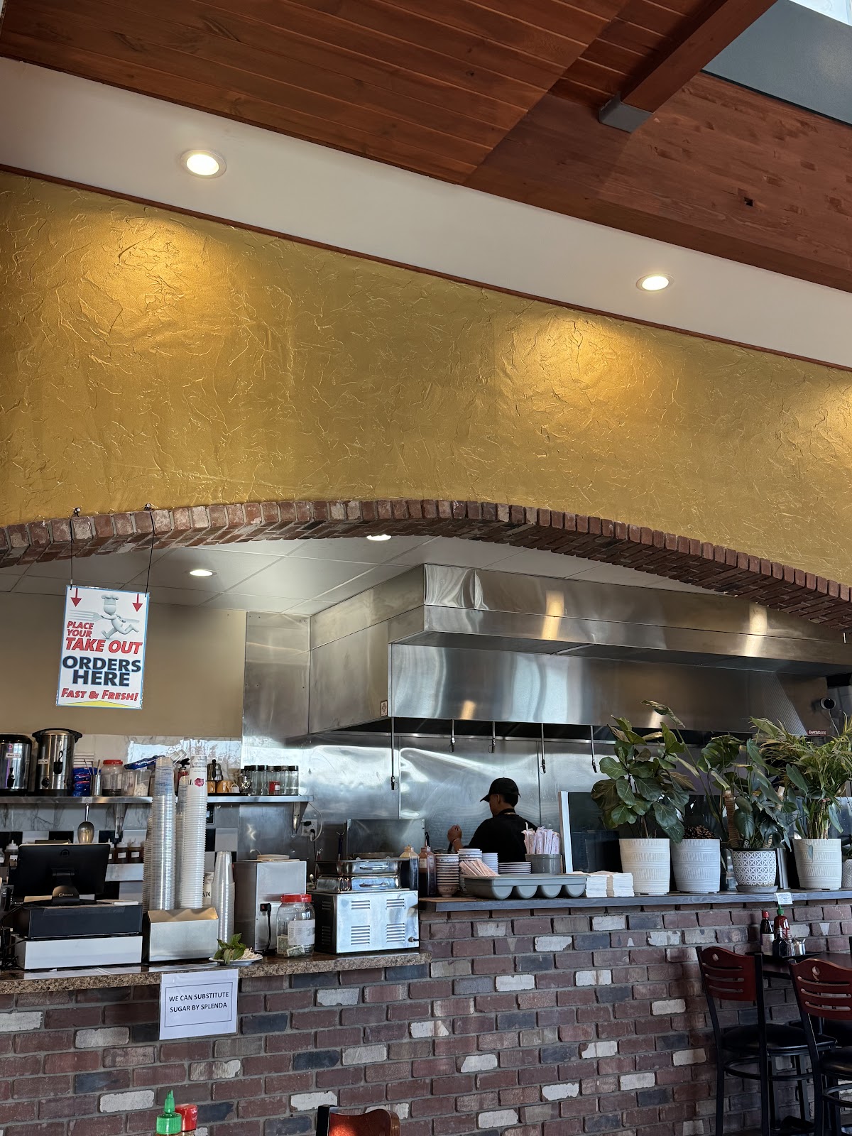 The open kitchen at Phở Road 68, broth on the stove